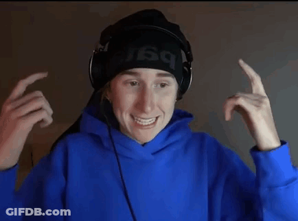 A Young Man Wearing Headphones And A Blue Hoodie Is Making A Face . GIF