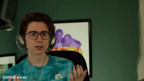 A Young Man Wearing Headphones And A Blue Tie Dye Shirt With A Cat On It GIF