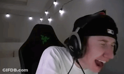 A Young Man Wearing Headphones And A Hat Is Sitting In A Chair . GIF
