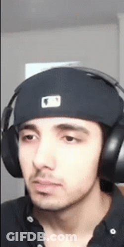 A Young Man Wearing Headphones And A Hat . GIF