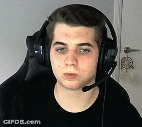 A Young Man Wearing Headphones And A Microphone Is Sitting In A Chair GIF