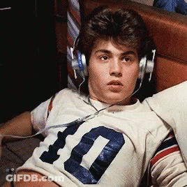 A Young Man Wearing Headphones And A Number 10 Jersey GIF