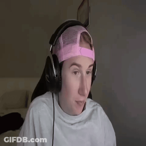 A Young Man Wearing Headphones And A Pink Hat . GIF