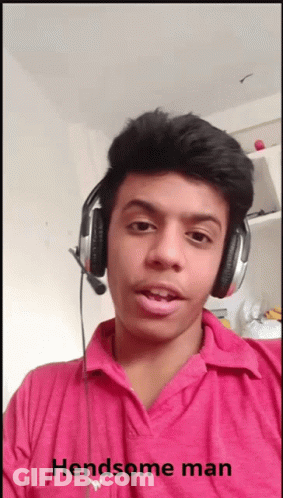 A Young Man Wearing Headphones And A Pink Shirt With The Words Handsome Man Below Him GIF