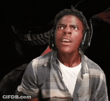 A Young Man Wearing Headphones And A Plaid Shirt Is Making A Surprised Face . GIF