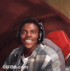 A Young Man Wearing Headphones And A Plaid Shirt Is Smiling GIF