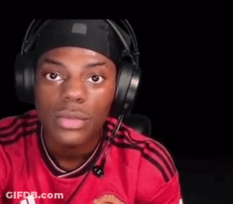 A Young Man Wearing Headphones And A Red Shirt Is Sitting In A Chair . GIF