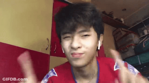 A Young Man Wearing Headphones Is Giving A Thumbs Up . GIF