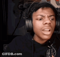 A Young Man Wearing Headphones Is Making A Funny Face . GIF