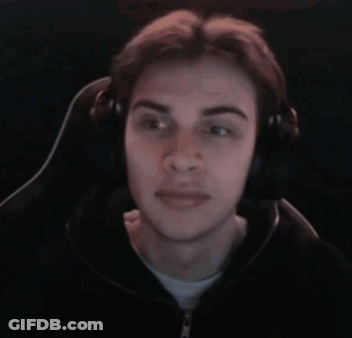 A Young Man Wearing Headphones Is Sitting In A Chair And Making A Funny Face . GIF