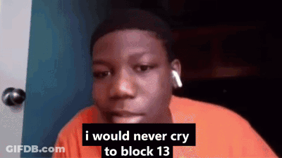 A Young Man Wearing Headphones Is Sitting In Front Of A Door . GIF