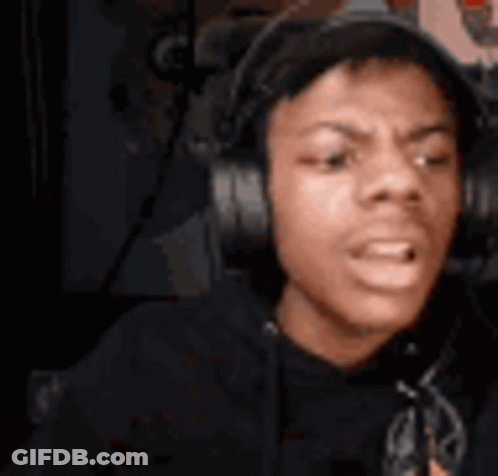 A Young Man Wearing Headphones Is Sitting In Front Of A Microphone And Making A Funny Face . GIF