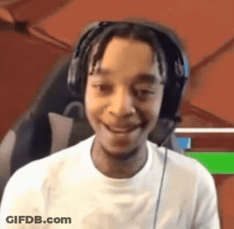 A Young Man Wearing Headphones Is Smiling In Front Of A Green Screen GIF