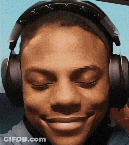 A Young Man Wearing Headphones Is Smiling With His Eyes Closed And His Mouth Open . GIF