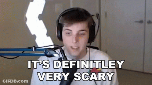 A Young Man Wearing Headphones Is Standing In Front Of A Microphone And Saying `` It 'S Definitely Very Scary '' GIF