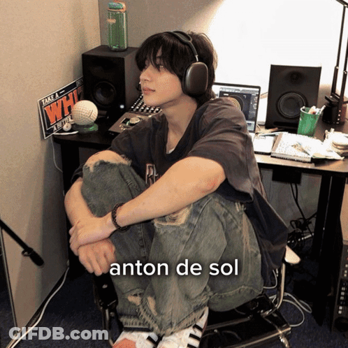 Young Man With Headphones Sitting At Desk With Take A Whi Sign GIF