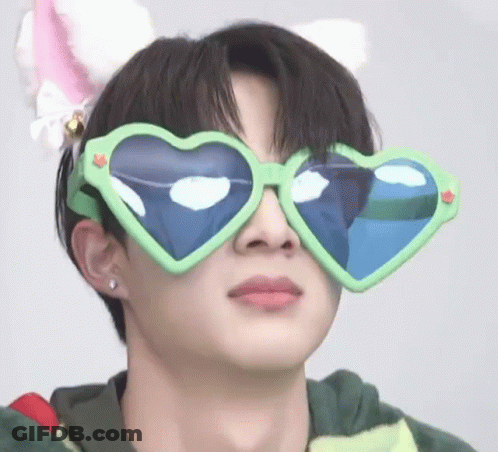A Young Man Wearing Heart Shaped Sunglasses And A Cat Ear Headband . GIF