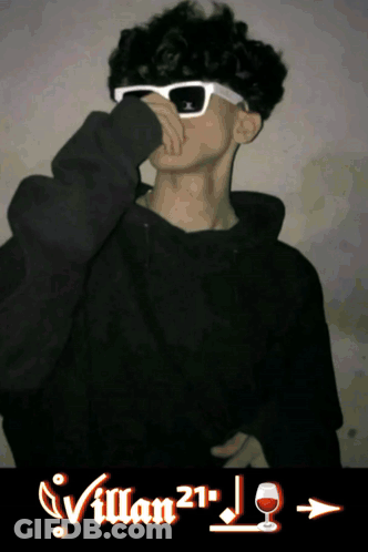 A Young Man Wearing Sunglasses And A Black Hoodie With Villan21 Written On The Bottom GIF