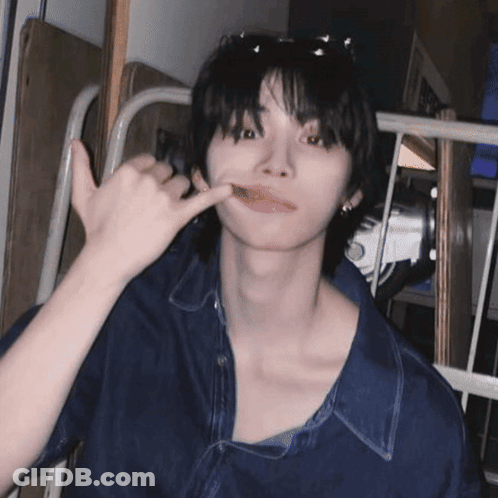 A Young Man Wearing Sunglasses And A Blue Shirt Is Making A Phone Call Sign GIF