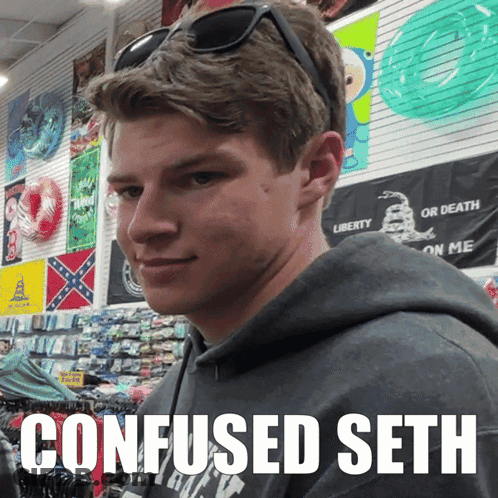 A Young Man Wearing Sunglasses And A Sweatshirt That Says Confused Seth Looks At The Camera GIF