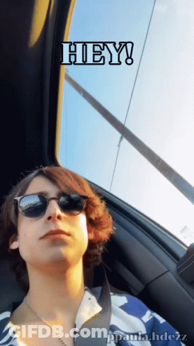 A Young Man Wearing Sunglasses Is Sitting In A Car With A Caption That Says Hey GIF