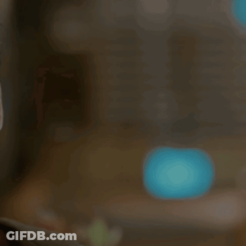 A Young Man Wearing Sunglasses Looks At The Camera With A Serious Look On His Face GIF