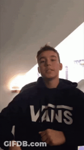 A Young Man Wears A Black Vans Sweatshirt GIF