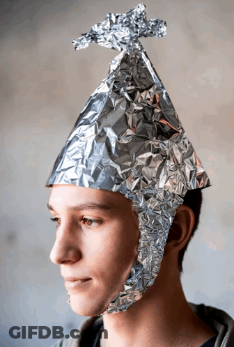 A Young Man Wears A Hat Made Of Aluminum Foil GIF