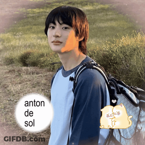 Young Man With Backpack In Field With Anton De Sol Text GIF
