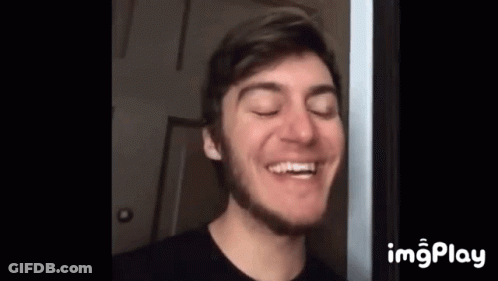 A Young Man With A Beard Is Smiling With His Eyes Closed And His Mouth Open . GIF