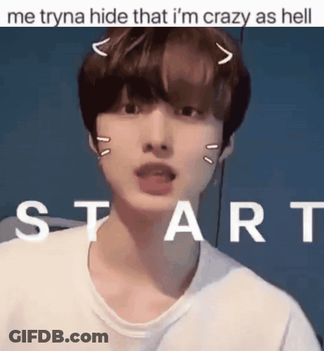 A Young Man With A Cat Ear On His Head Is Standing In Front Of A Sign That Says Start GIF