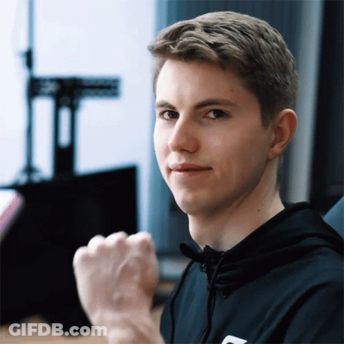 A Young Man With A Fist In The Air Is Wearing A Black Hoodie GIF