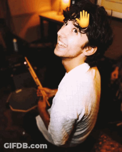 A Young Man With A Hand On His Head Playing Drums GIF