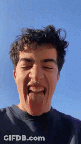 A Young Man With A Nose Ring Sticking His Tongue Out GIF