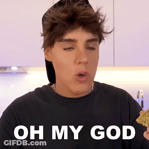 A Young Man With A Piercing In His Lip Is Holding A Piece Of Food With The Words Oh My God Below Him GIF