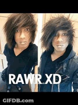 A Young Man With A Piercing In His Lip Is Wearing A Black Shirt And A Black Jacket And Taking A Selfie . GIF