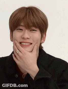 A Young Man With A Ring On His Finger Covering His Mouth With His Hand . GIF