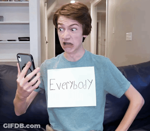 A Young Man With A Sign That Says Everybody GIF