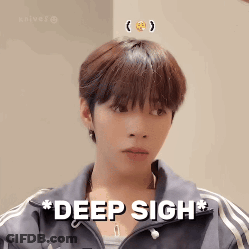 A Young Man With A Smiley Face On His Head Is Wearing A Jacket That Says Deep Sigh GIF