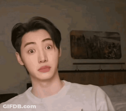 A Young Man With A Surprised Look On His Face Wearing A White Shirt GIF