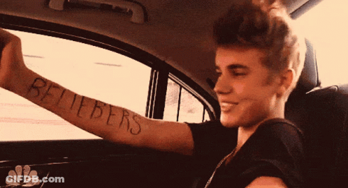 A Young Man With A Tattoo On His Arm That Says Believers GIF