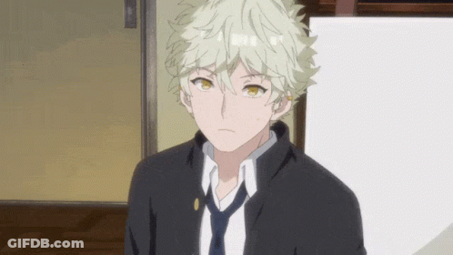 A Young Man With Blonde Hair And A Black Jacket And Tie GIF