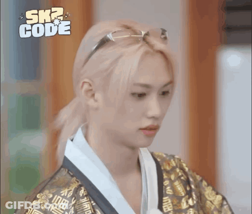 A Young Man With Blonde Hair And Glasses Is Wearing A Kimono And A Ponytail . GIF