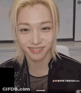 A Young Man With Blonde Hair Is Smiling And Wearing A Black Jacket GIF