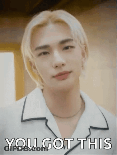 A Young Man With Blonde Hair Is Wearing A White Shirt And A Necklace And Says You Got This . GIF