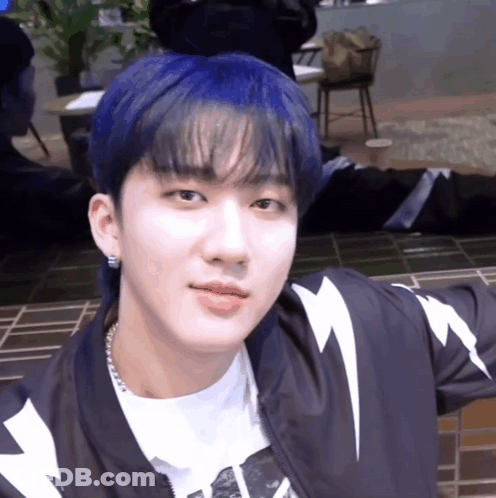 A Young Man With Blue Hair And A Lightning Bolt Jacket GIF