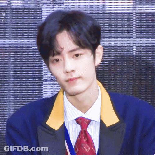 A Young Man With Blue Hair And A Red Tie GIF