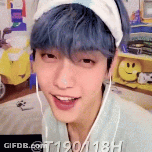 A Young Man With Blue Hair Is Wearing A Headband And Headphones . GIF