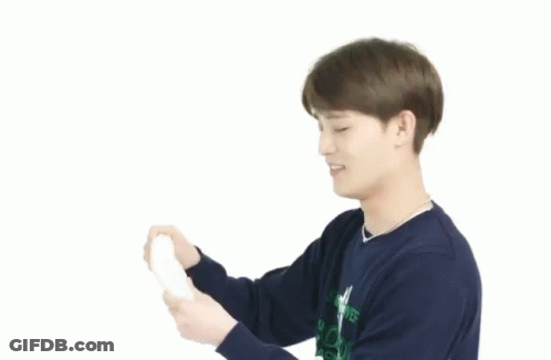 A Young Man With Brown Hair Is Smiling And Wearing A Necklace . GIF
