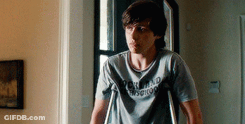 A Young Man With Crutches Is Wearing A Rock And Roll Shirt GIF